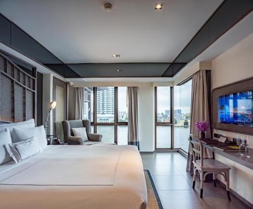 Tempat tidur dalam kamar di Riva Surya Bangkok