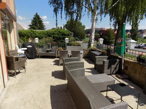 a patio with couches and chairs on a sidewalk at ElbPension & Ferienwohnung Sächsische Schweiz in Pirna