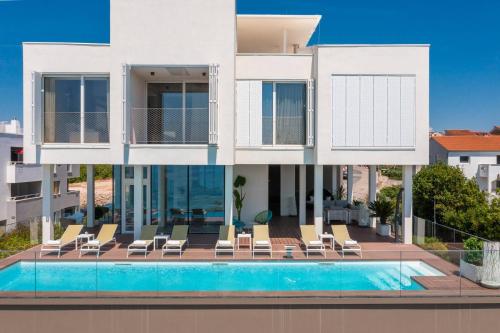 een groot wit huis met een zwembad bij Dedaj Resort - Villa Tina in Zadar