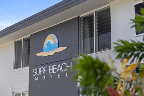 a sign for a surf beach motel on the side of a building at Surf Beach Motel Coffs in Coffs Harbour