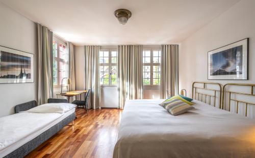 Hotel Hofgarten Luzern tesisinde bir odada yatak veya yataklar