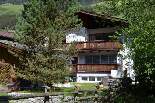 um edifício com uma varanda e uma cerca em Appartement Nischler em Wald im Pinzgau