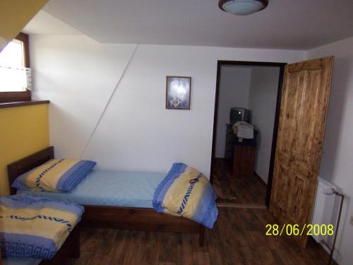 a small bedroom with a bed and a mirror at Penzion Silverado in Horní Bečva