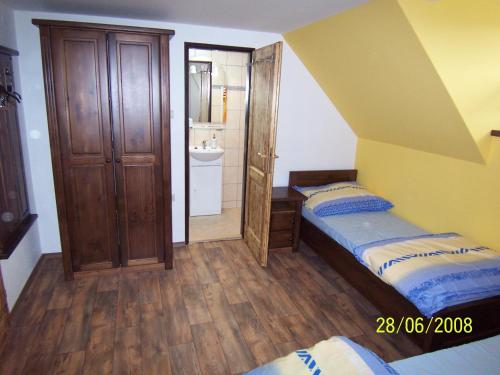 a small bedroom with a bed and a bathroom at Penzion Silverado in Horní Bečva