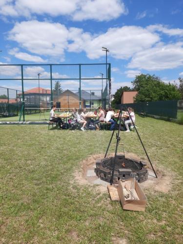 Un groupe de personnes assises autour d'un feu dans un parc dans l'établissement Agroturystyka dom z bali całoroczny, à Turbia