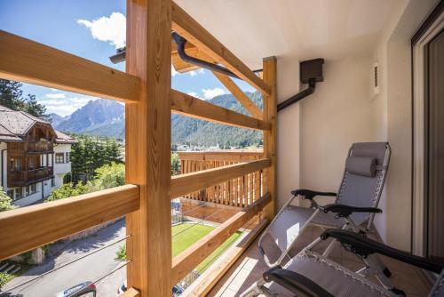 een fitnessruimte met uitzicht op de bergen vanaf een balkon bij Apartment Cinch Residence Bun Ste in San Vigilio Di Marebbe