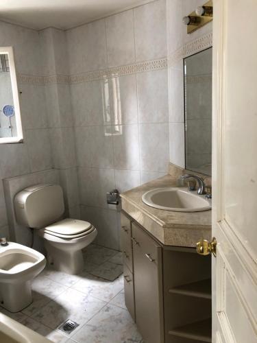 a bathroom with a toilet and a sink at B&B 518 in La Paz