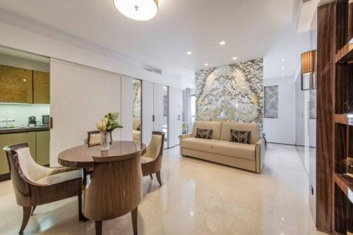 a living room with a table and a couch at Milan Royal Suites - Centro in Milan