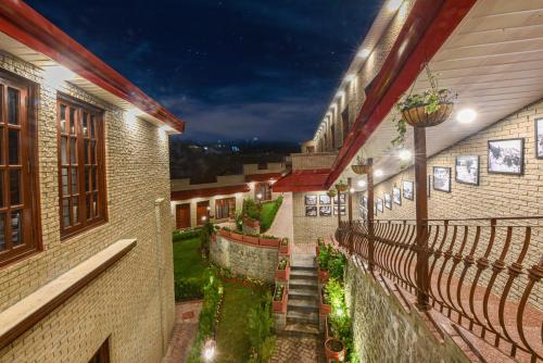 an outdoor pathway between two buildings at night at Khattak Lodge Murree in Murree