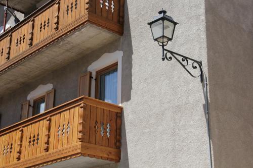 a street light on the side of a building with a balcony at Appartamenti Dany in Arabba