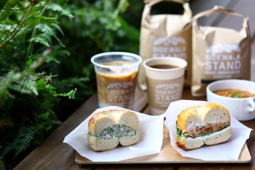 two sandwiches on a table with two cups of coffee at MUSTARD HOTEL SHIMOKITAZAWA in Tokyo