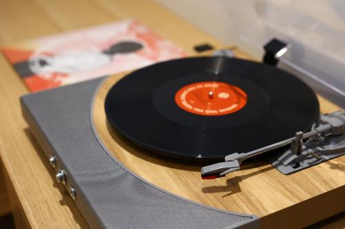 a vinyl record sitting on top of a table at MUSTARD HOTEL SHIMOKITAZAWA in Tokyo