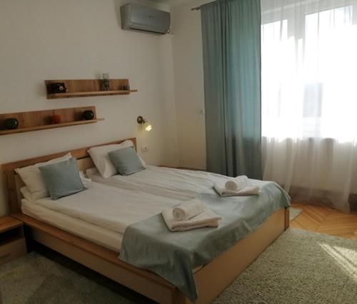 - une chambre avec un grand lit et des serviettes dans l'établissement Check-In Kaya, à Sibiu