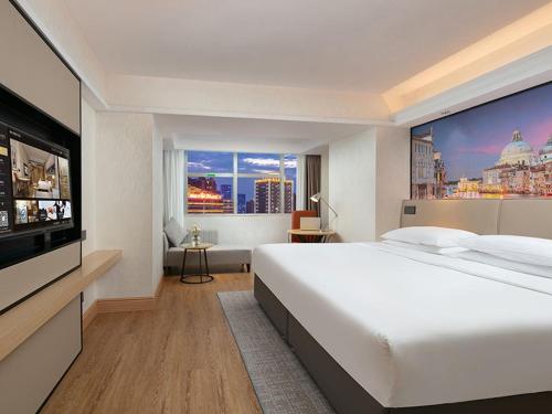 Cama ou camas em um quarto em Vienna International Hotel Changsha Furong Plaza