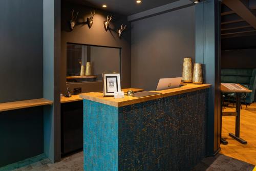 a room with a counter with a laptop on it at Waldhotel Riesebusch in Bad Schwartau