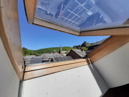 a window with a view of a city at Au bord de l'Ourthe in La Roche-en-Ardenne