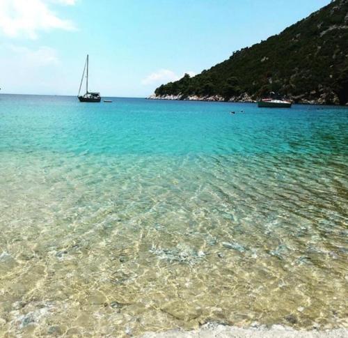 vista sull'oceano con barca a vela in acqua di Limnonari Beach Rooms a Skopelos Town