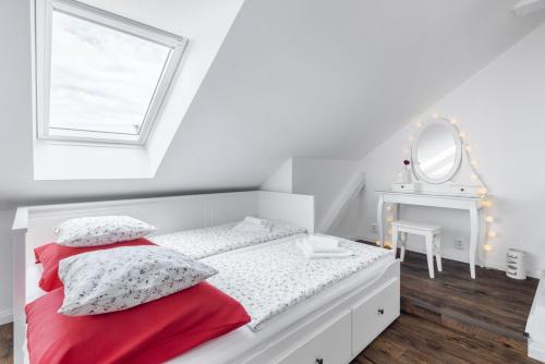 - une chambre blanche avec un lit et un miroir dans l'établissement Penzion Belle Donne, à Znojmo