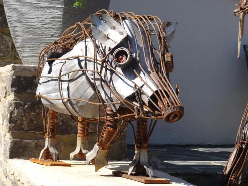 a statue of a horse in a fence at B&B Le bruissement in Bièvre