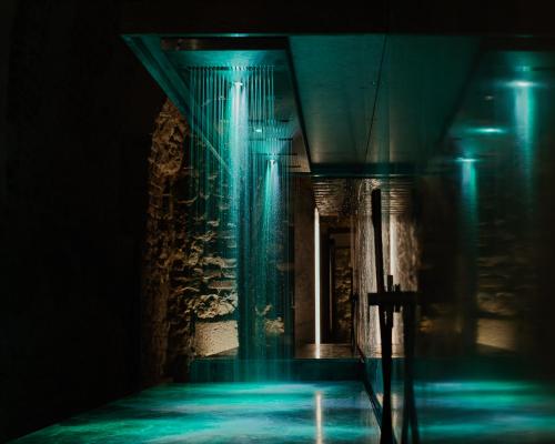 a dark hallway with blue lights in a building at Hotel Pod Różą in Kraków