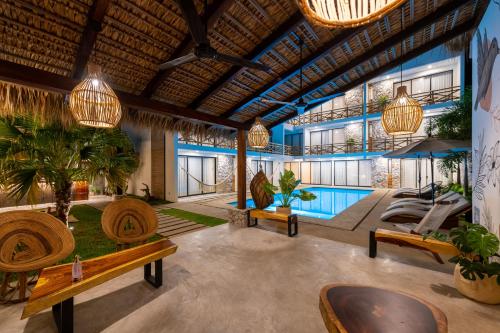 una hall con piscina, panchine e piante in vaso di Casa Bicachi - Adults Only a Puerto Escondido