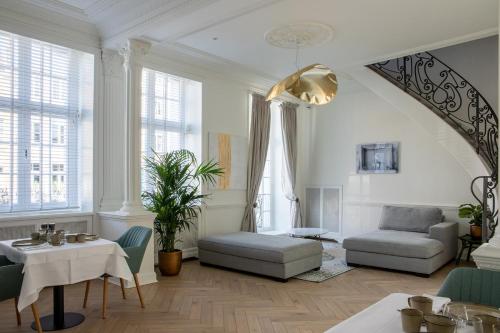 a living room with a couch and a table at Molenmeers Boutique Guesthouses in Bruges