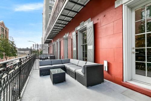 a patio with a couch on a red building at The Calliope in New Orleans