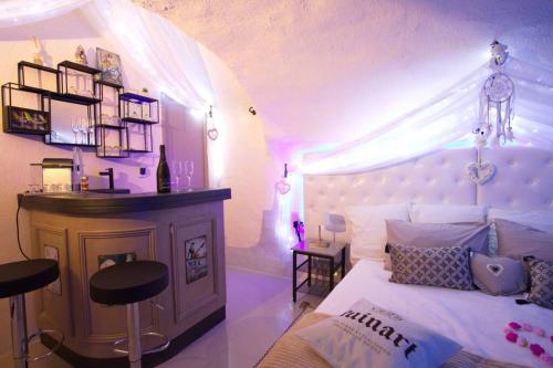 a bedroom with a large bed with a white canopy at Les Secrets d'Alcôve, nuits Romantiques avec SPA in Aix-en-Provence