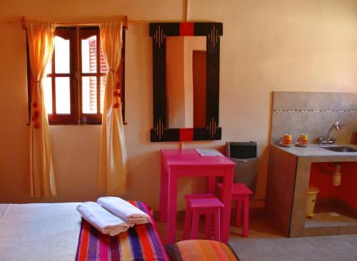 A bed or beds in a room at Hostal Paseo de los Colorados