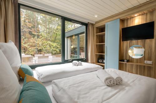 Кровать или кровати в номере Center Parcs Bispinger Lüneburger Heide