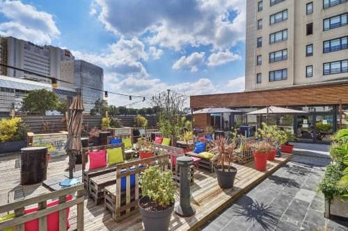 a patio with a bunch of potted plants at Novotel Suites Paris Montreuil Vincennes in Paris