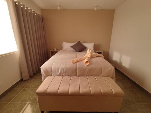 a bedroom with a bed with a stuffed animal on it at Lilium Apartment & Experiences in Arequipa