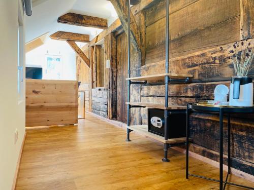 a kitchen with wooden walls and a wooden floor at RotmeerHaus in Feldberg