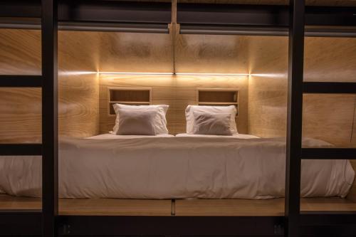 A bed or beds in a room at GiG Capsule Hostel