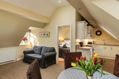 a living room with a couch and a table at Self contained accommodation near Delamere forest in Oakmere