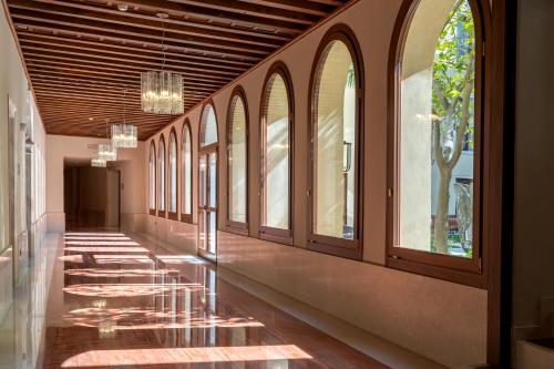 a hallway with a row of windows in a building at Ca'di Dio-Small Luxury Hotel in Venice