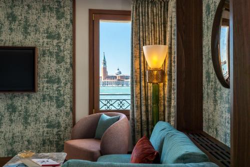 a living room with a couch and a window at Ca'di Dio-Small Luxury Hotel in Venice