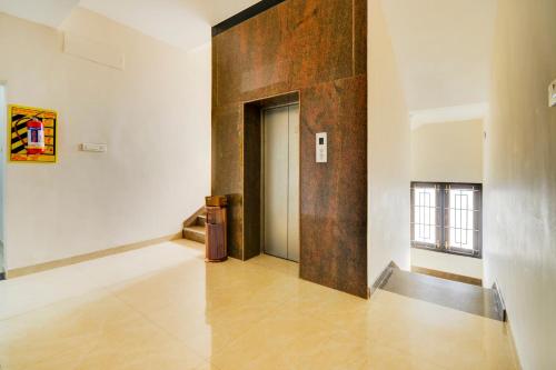 a hallway with a large wooden wall in a building at Mayfair Service Apartments in Pīlamedu