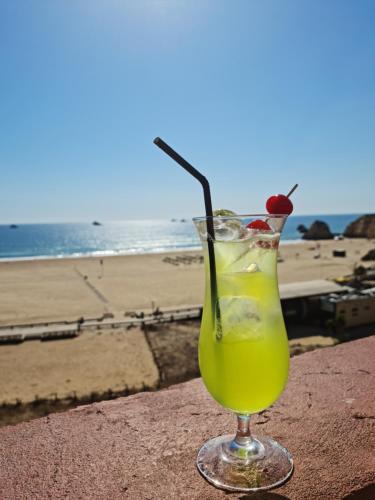 uma bebida sentada numa saliência junto à praia em Portugal Algarve Beach Apartment em Portimão