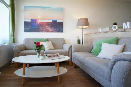 ein Wohnzimmer mit einem Sofa und einem Tisch in der Unterkunft Apartment Baltic Panorama in Heiligenhafen