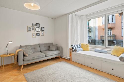 a living room with a couch and a window at Modern & Central Apartments in Luzern