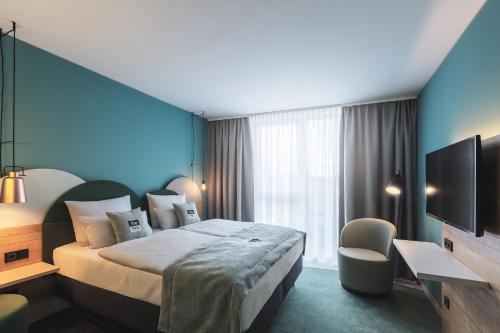 Tempat tidur dalam kamar di Holiday Inn - the niu, Cure Erlangen, an IHG Hotel