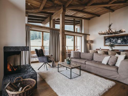 a living room with a couch and a fireplace at VAYA St Zeno Serfaus in Serfaus