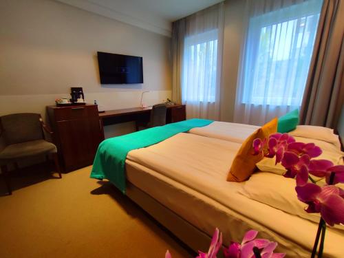 Кровать или кровати в номере Hotel Zamek Centrum