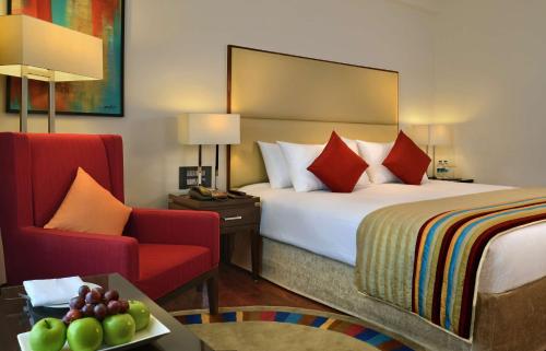 A bed or beds in a room at Park Plaza Chandigarh Zirakpur