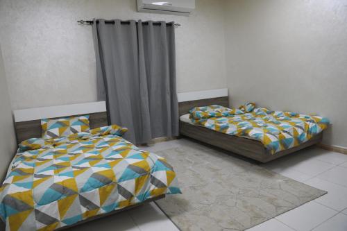 Una cama o camas en una habitación de Aljood Resort