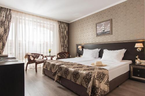 a hotel room with a large bed and a window at Hotel & SPA Diamant Residence - All Inclusive in Sunny Beach