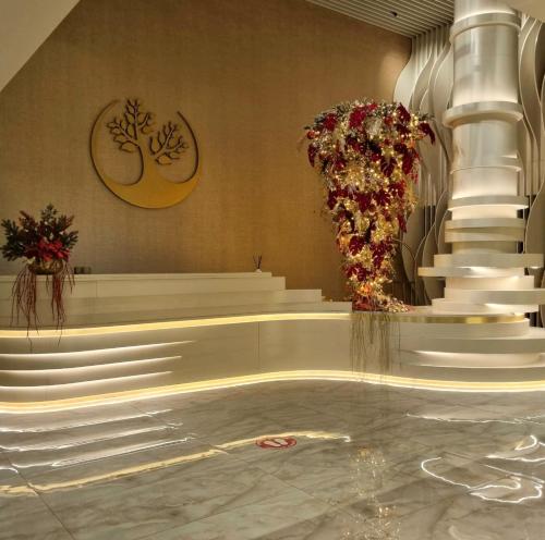 a lobby with white steps and flowers on the wall at Green Suites Boutique Hotel in Athens