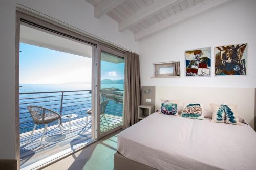 una camera con letto e balcone di Hotel Caramare a Cala Gonone