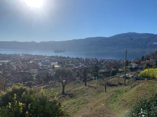 a view of a city and a lake from a hill at Sole in Verbania